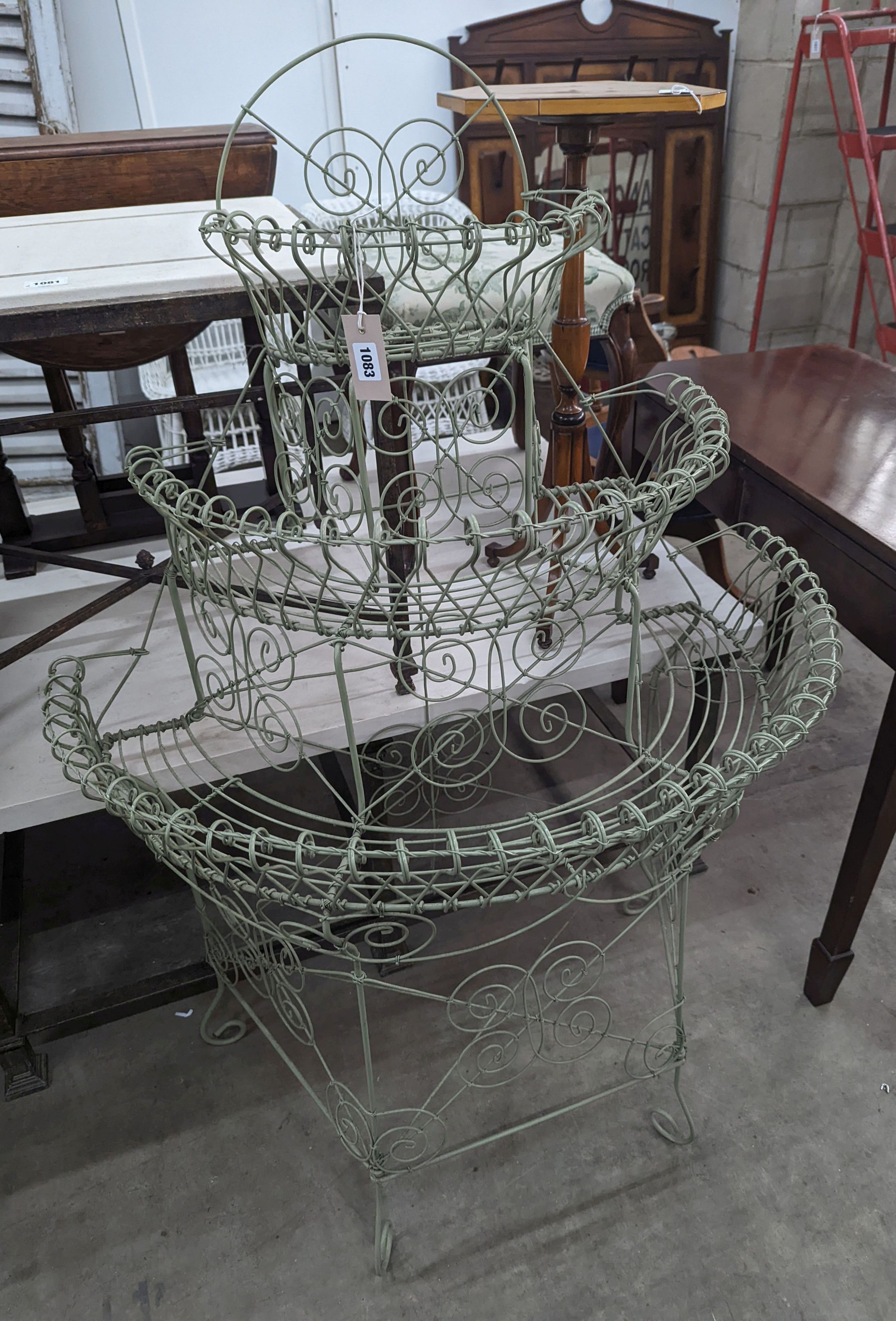 A Victorian style painted wirework plant stand, width 84cm, depth 54cm, height 130cm